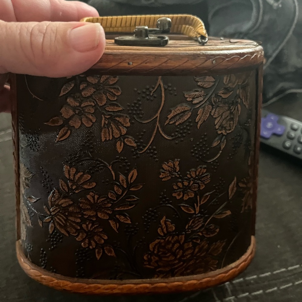 This is a vintage bohemian wood purse with a floral design.